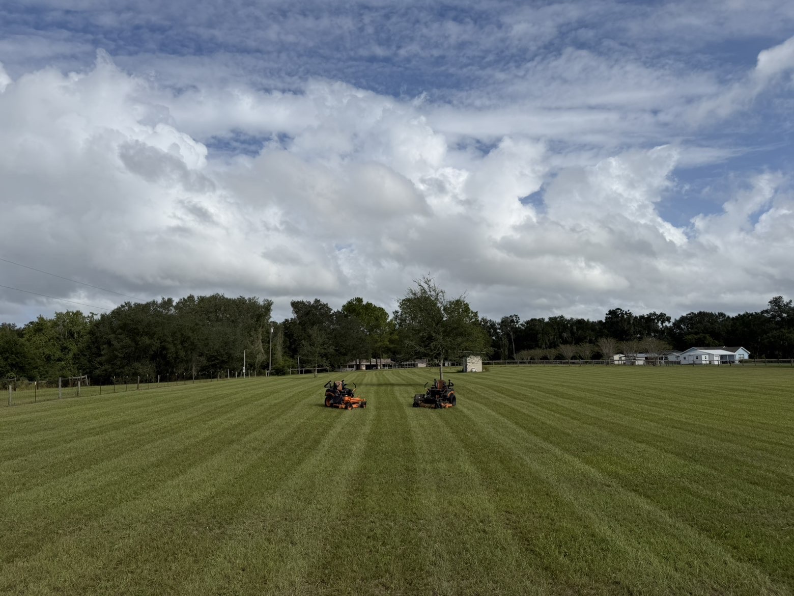 Freshly mowed open field with two mowers